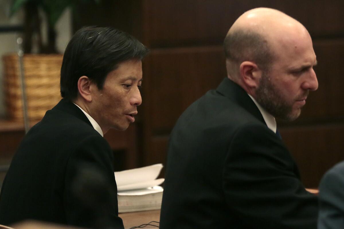 Gianni Anthony Van, left, sits with attorney Jeremy Dolnick during his murder trial in Santa Ana in April.
