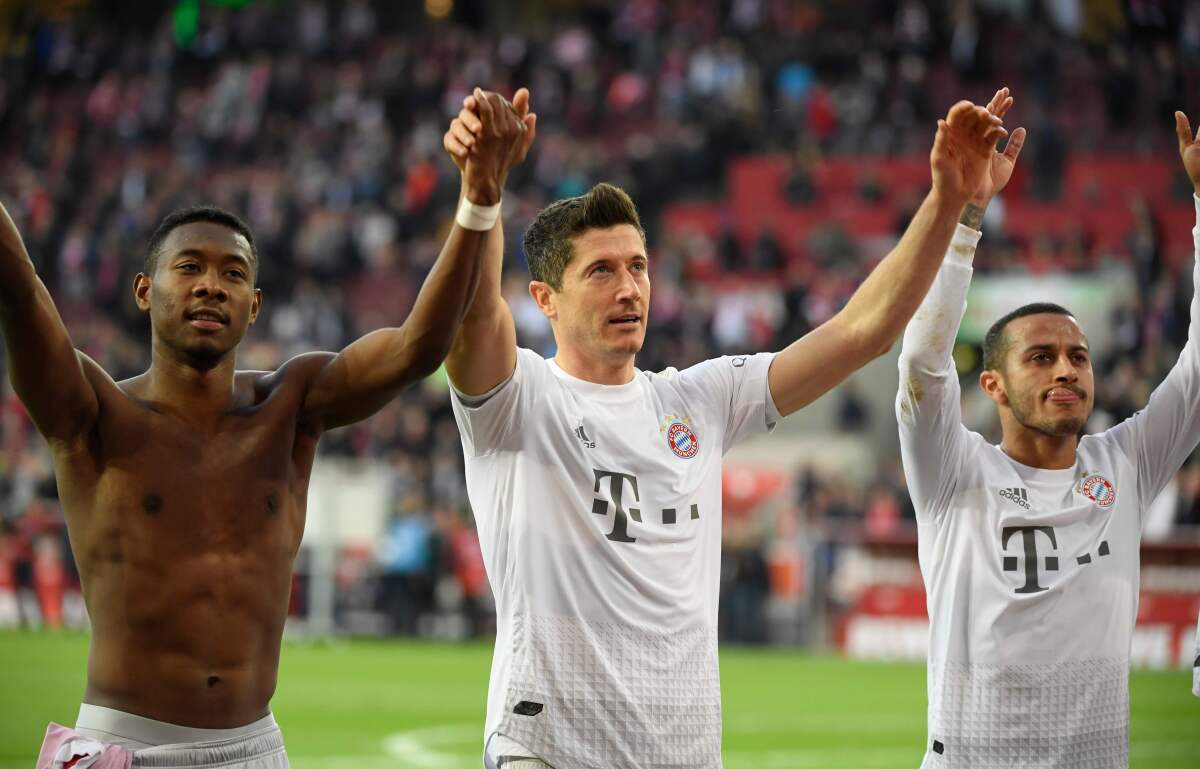 (L-R) Bayern Munich's Austrian defender David Alaba, Bayern Munich's Polish forward Robert Lewandowski and Bayern Munich's Spanish midfielder Thiago Alcantara celebrate victory after the German first division Bundesliga football match 1 FC Cologne v FC Bayern Munich in Cologne, western Germany on February 16, 2020. (Photo by INA FASSBENDER / AFP) / RESTRICTIONS: DFL REGULATIONS PROHIBIT ANY USE OF PHOTOGRAPHS AS IMAGE SEQUENCES AND/OR QUASI-VIDEO (Photo by INA FASSBENDER/AFP via Getty Images) ** OUTS - ELSENT, FPG, CM - OUTS * NM, PH, VA if sourced by CT, LA or MoD **
