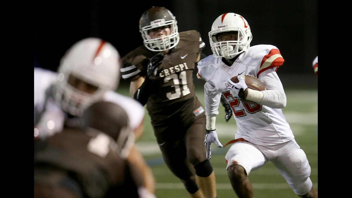 Orange Lutheran receiver Malone Mataele looks for room to run against Crespi in the third quarter Friday night.