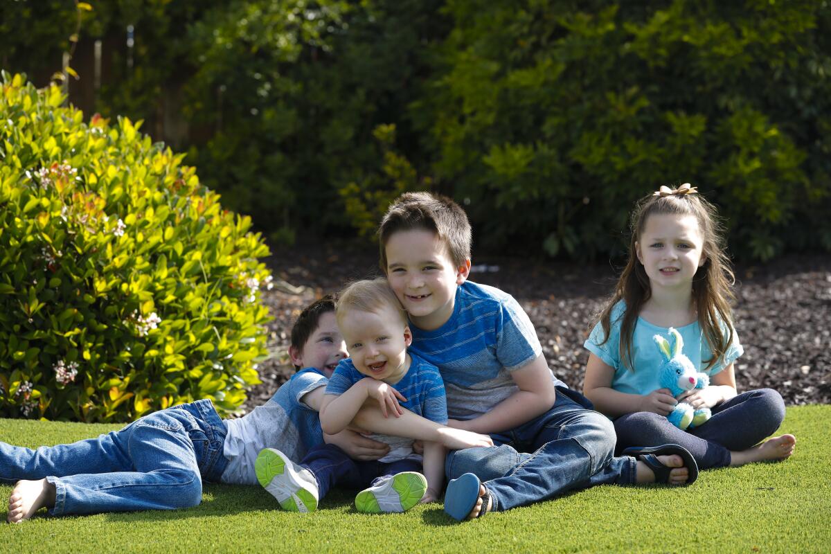 Charlie Luckesen, 2, enjoyed playing with his three siblings, William, 6; Jack, 8; and Amelia, 5, during their playtime on the front yard of the family's home.