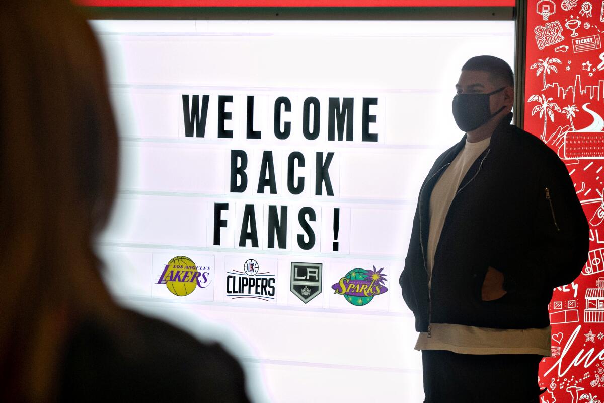 Staples Center staff prepare for fans to return to the arena for the Lakers-Celtics game on Thursday.