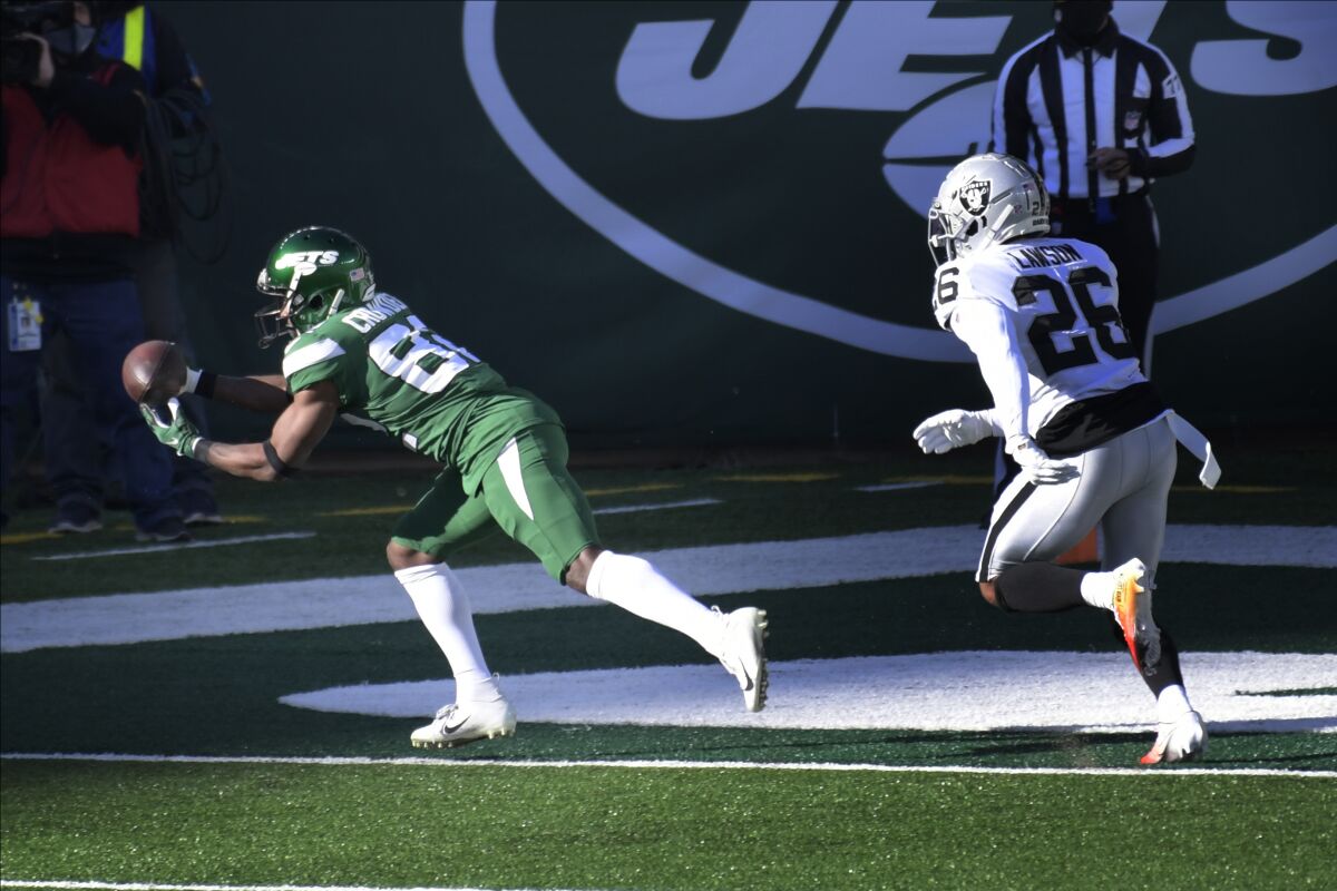 New York Jets' Jamison Crowder, left, catches a pass for a touchdown during the first half an NFL football game against the Las Vegas Raiders, Sunday, Dec. 6, 2020, in East Rutherford, N.J. (AP Photo/Bill Kostroun)