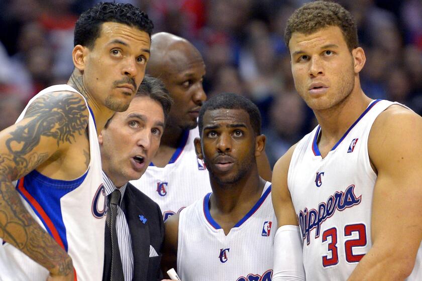 Lamar Odom, rear center, was part of the 2012-13 Clippers team along with, from left, Matt Barnes, Coach Vinny Del Negro, Chris Paul and Blake Griffin.