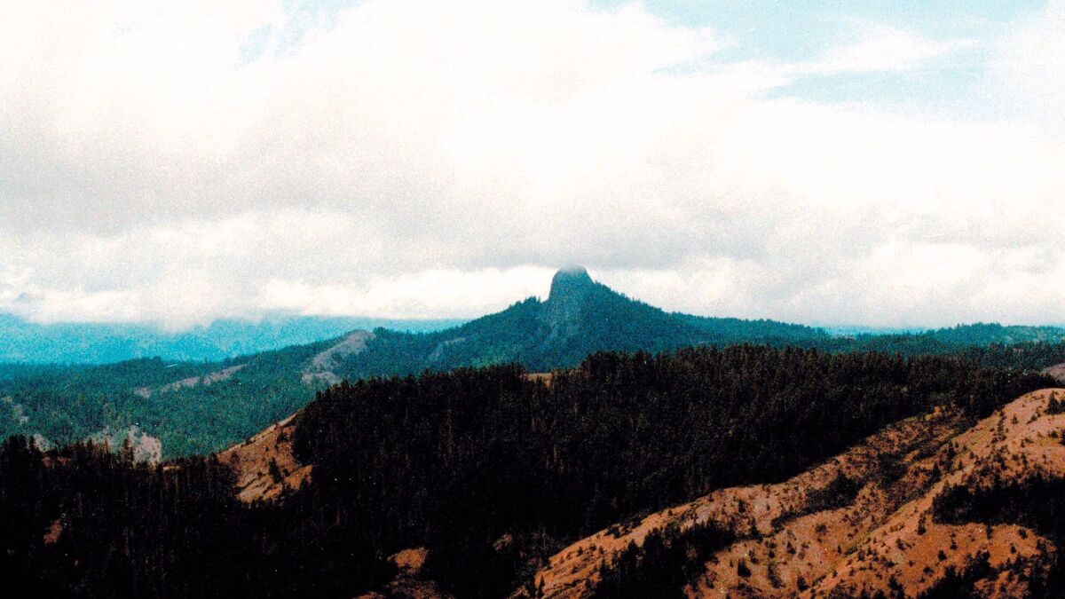 Pilot Rock rises into the clouds in the Cascade-Siskiyou National Monument near Lincoln, Ore.