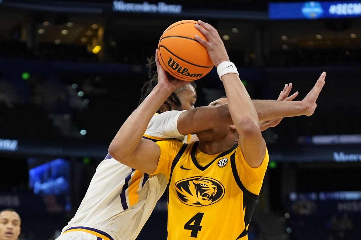 LSU center Efton Reid, left, fouls Missouri guard Javon Pickett (4) as he goes up for a shot during the second half of an NCAA men's college basketball game at the Southeastern Conference tournament in Tampa, Fla., Thursday, March 10, 2022. (AP Photo/Chris O'Meara)