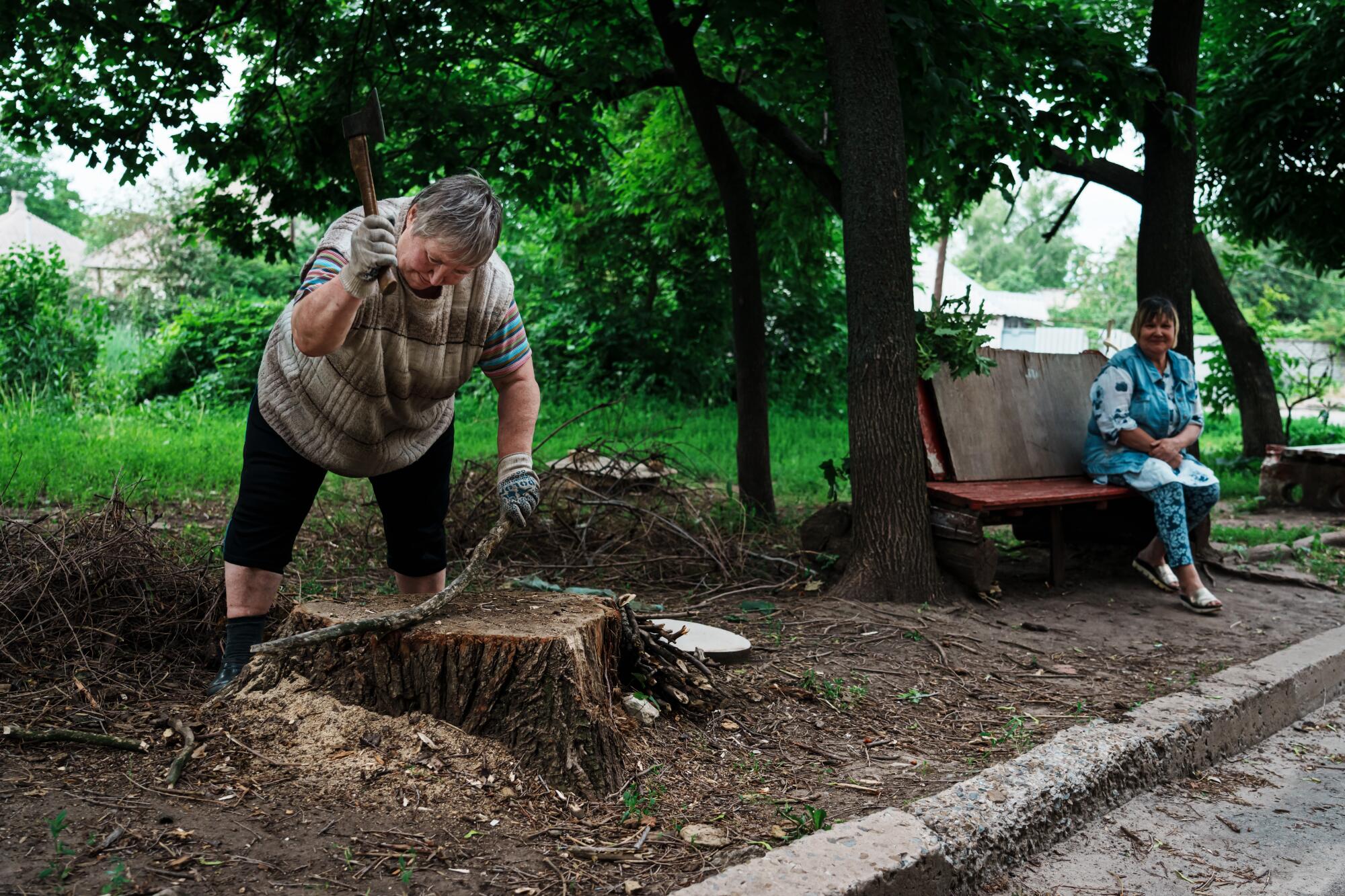 Liubov Vedeneeva, chops firewood in Lysychansk, Ukraine. "Time flies fast when you are having fun," she shrugs.