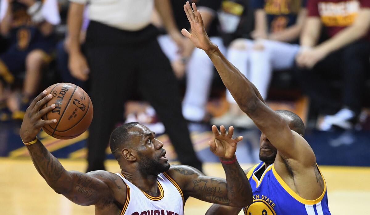 Cleveland Cavaliers' LeBron James drives to the basket against Golden State Warriors' Andre Iguodala during the first half in Game 3 of the NBA Finals on Wednesday.