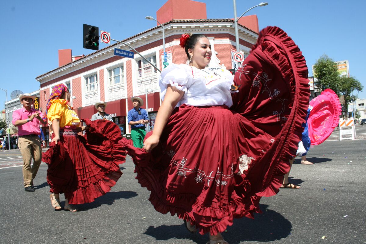 Integrantes del ballet folcórico ASOSAL muestran sus danzas y trajes pintorescos en el desfile salvadoreño.