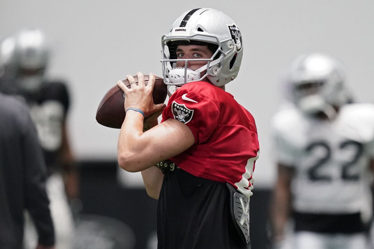 FILE - Las Vegas Raiders quarterback Derek Carr (4) prepares to throw a pass during an NFL football training camp practice Tuesday, Aug. 18, 2020, in Henderson, Nev. The Raiders play the Carolina Panthers on Sunday, Sept. 13.(AP Photo/John Locher, Pool, File