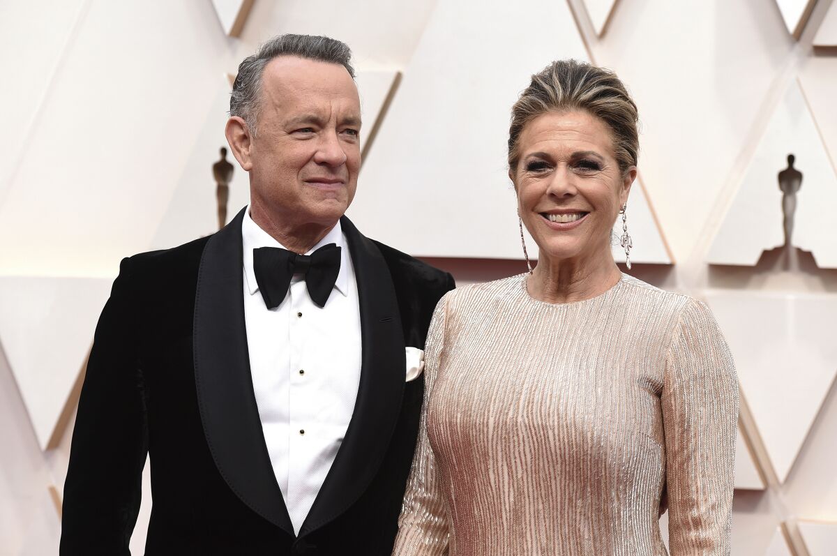 In this Feb. 9, 2020 file photo, Tom Hanks, left, and Rita Wilson arrive at the Oscars at the Dolby Theatre in Los Angeles. 