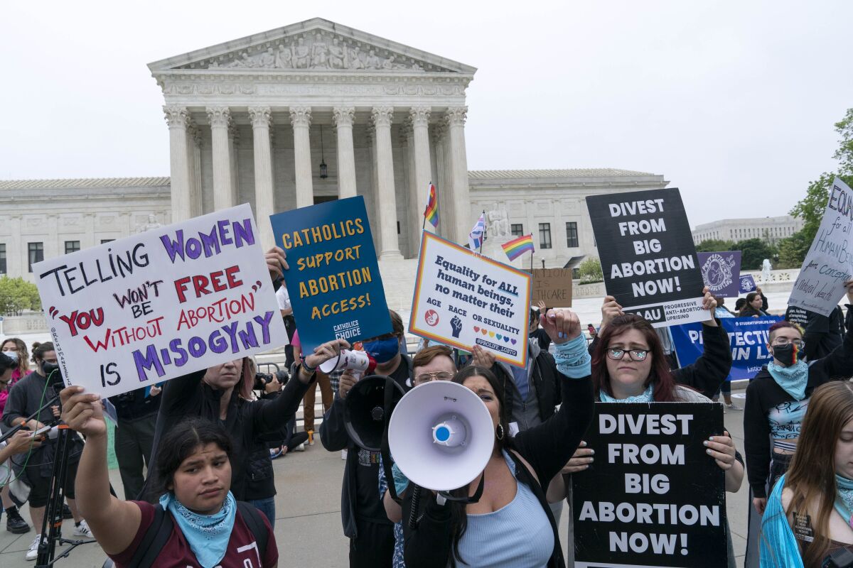 Demonstrators protest outside of the U.S. Supreme Court on Tuesday.
