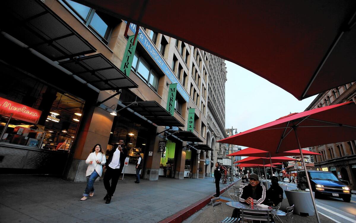 Customers now sit where traffic once did: on Broadway — at tables and under umbrellas — in front of Grand Central Market.