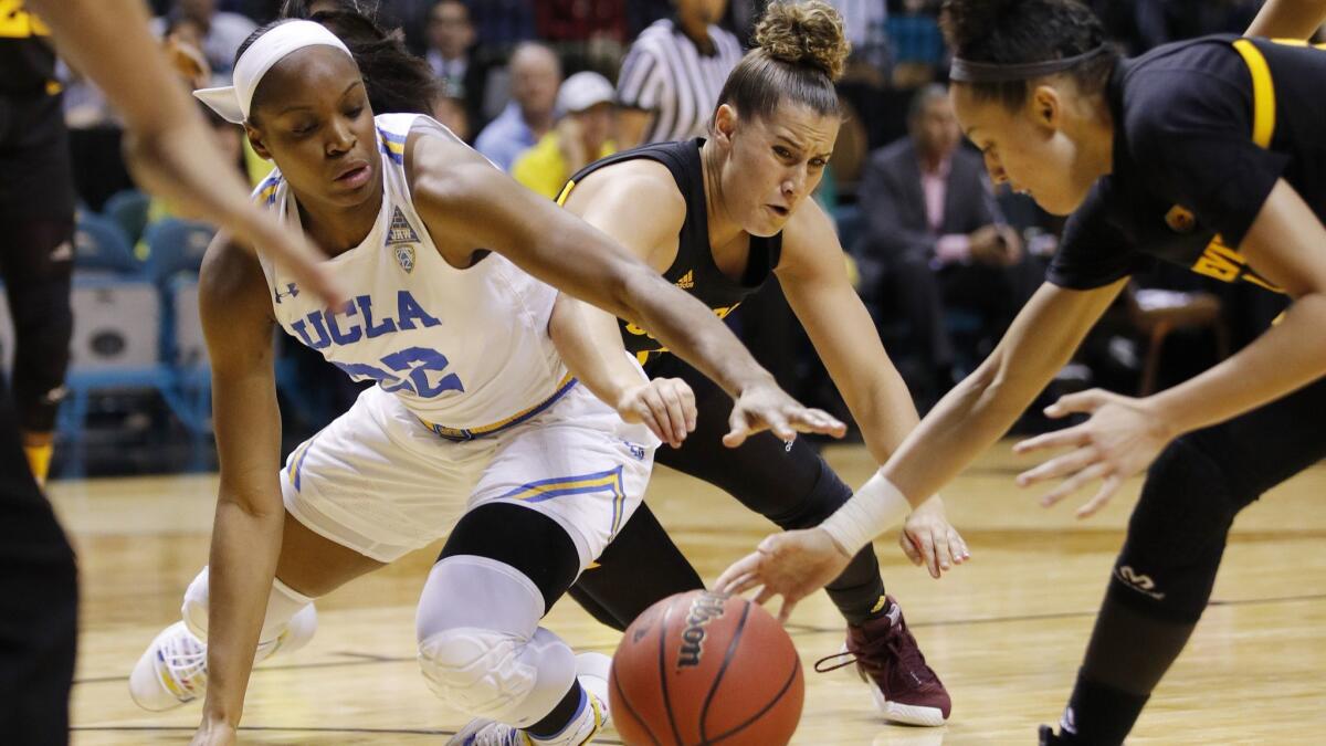 UCLA's Kennedy Burke, left, battles Arizona State's Taya Hanson, center, and and Reili Richardson for a loose ball during the Bruins' 73-69 victory in the Pac-12 tournament on Friday.