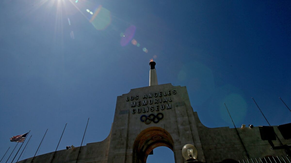 The Olympic torch burns atop the Los Angeles Memorial Coliseum after the city was officially awarded the rights to host the 2028 Olympic Games on Sept. 13, 2017.