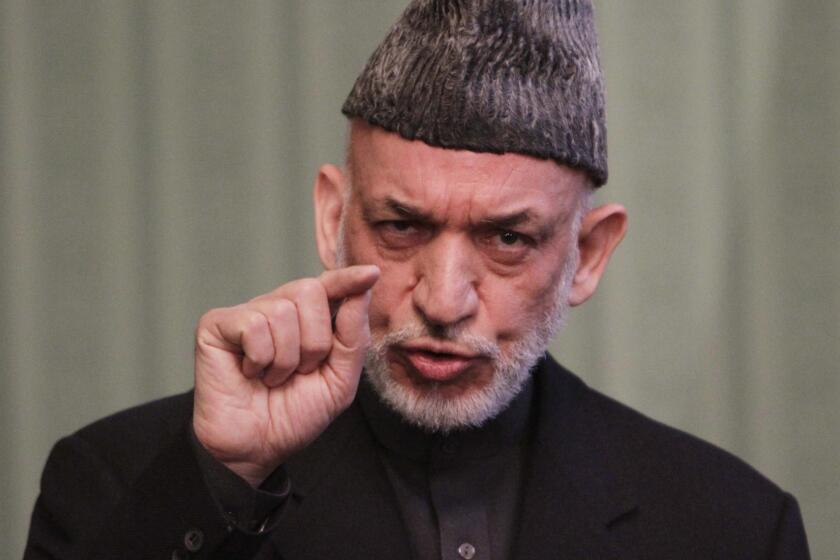Afghan President Hamid Karzai speaks to journalists during a press conference in Kabul. Karzai said that Washington needs to make concrete steps towards peace with the Taliban before Afghanistan will sign an agreement to allow a continued U.S. military presence in his country.