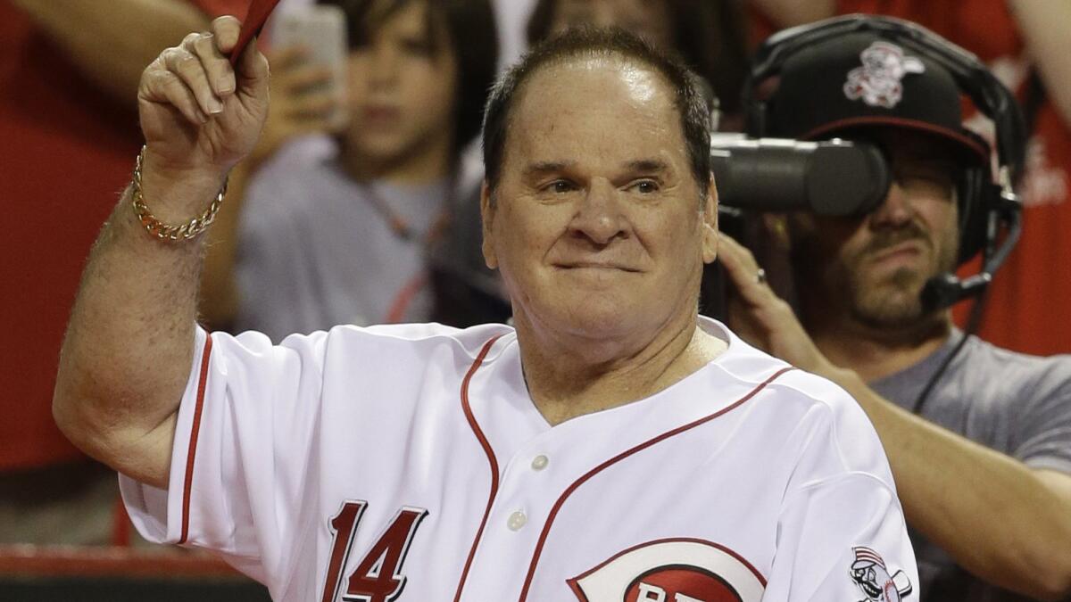 Former Cincinnati Reds great Pete Rose acknowledges the crowd during a ceremony at Great American Ball Park in Cincinnati on Sept. 6, 2013.