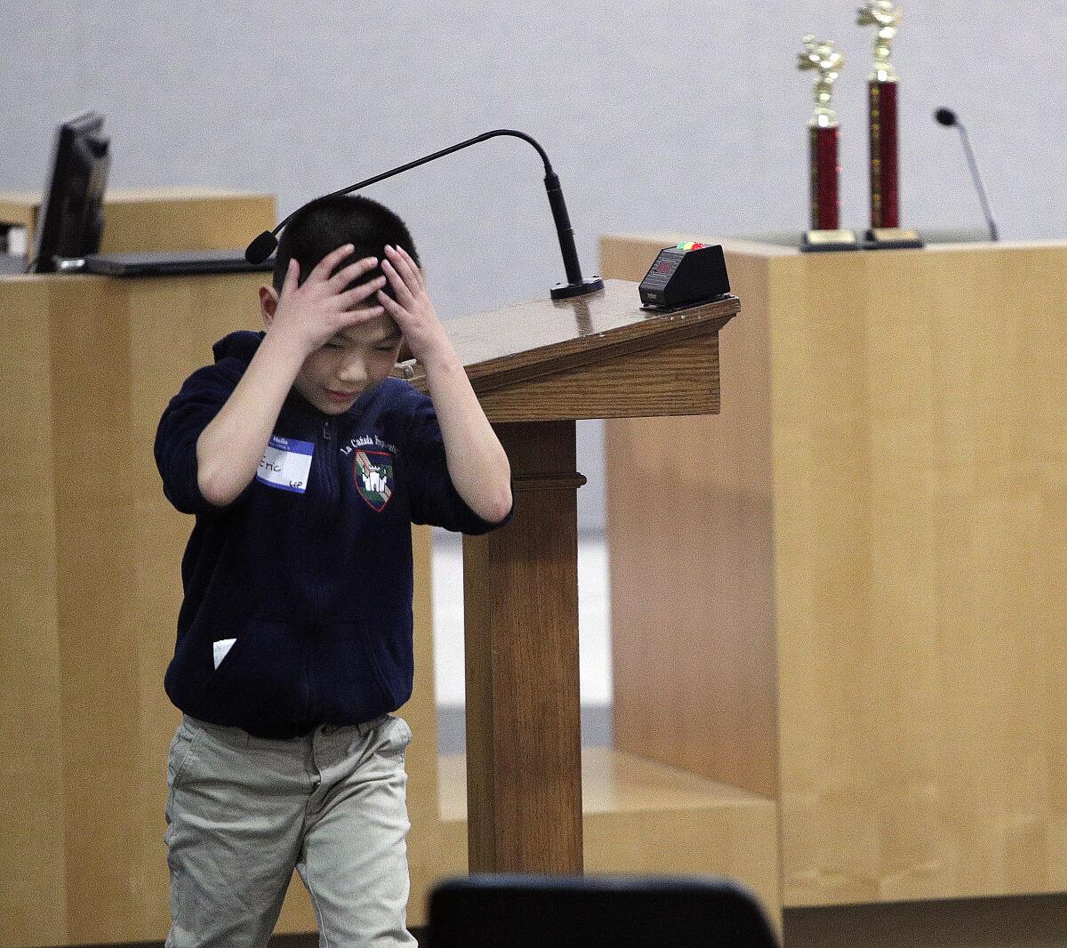 La Cañada Preparatory School's Eric Truong leaves the podium in upset after spelling a word incorrectly in the LCUSD district spelling bee on Monday, January 13, 2020.