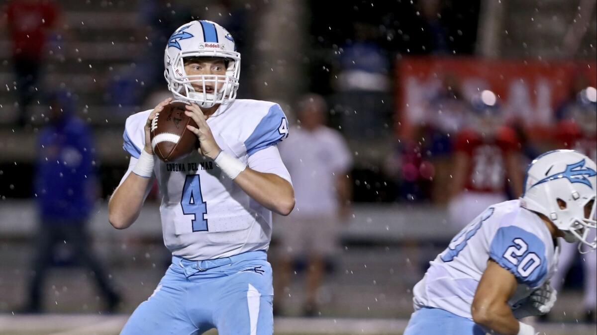Corona del Mar High quarterback Ethan Garbers, shown dropping back against Los Alamitos on Oct. 12, leads the Sea Kings into the 57th Battle of the Bay rivalry game against Newport Harbor on Friday.