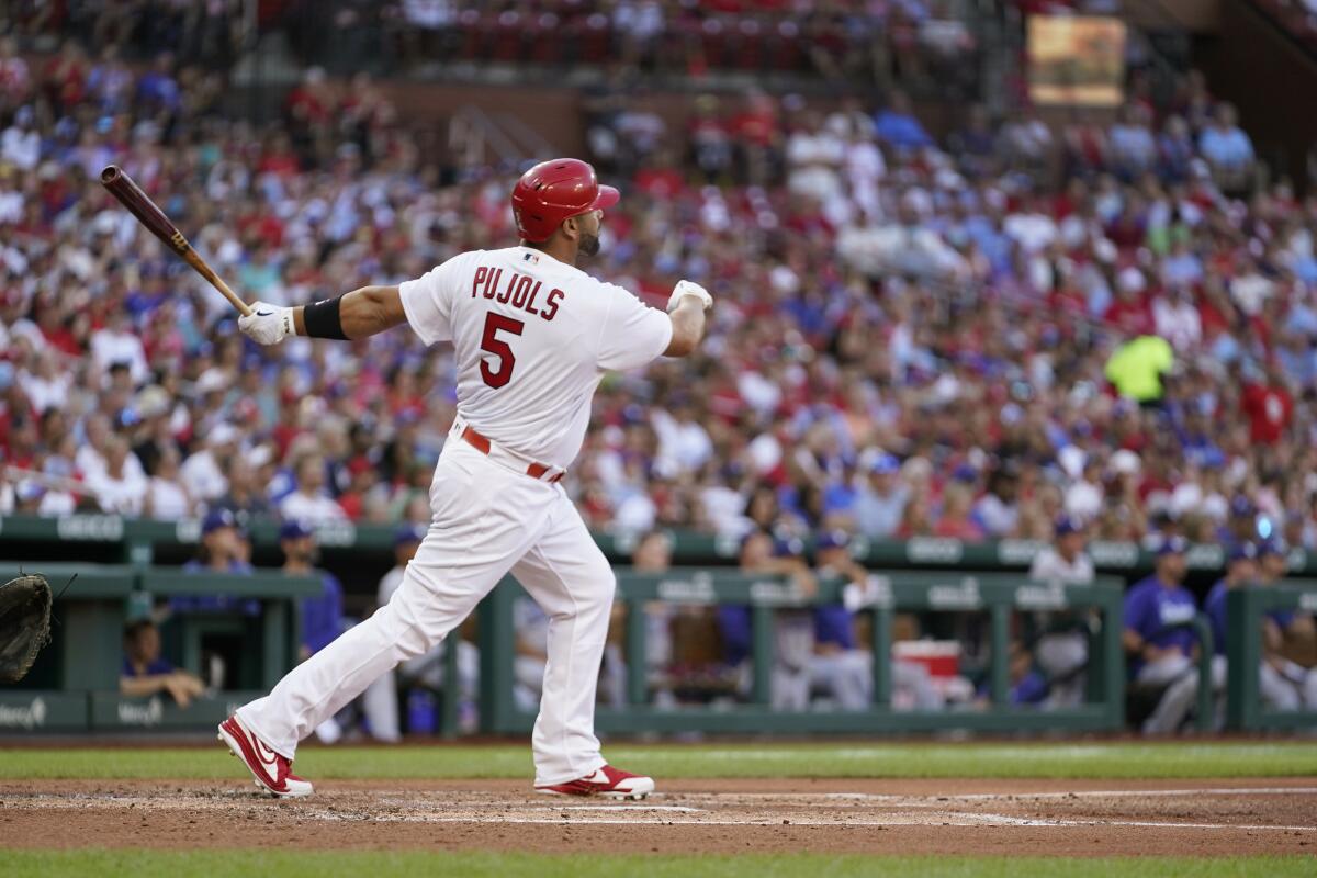St. Louis Cardinals' Albert Pujols watches his solo home run' during the second inning of a baseball game against the Los Angeles Dodgers Tuesday, July 12, 2022, in St. Louis. (AP Photo/Jeff Roberson)