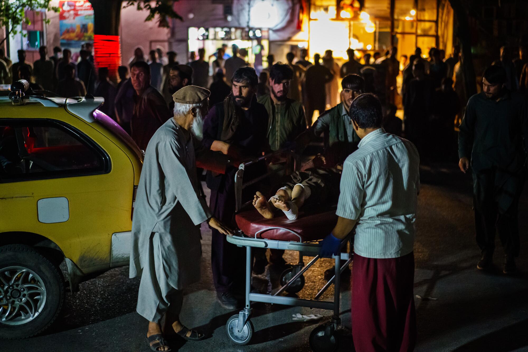 A wounded patient is brought by taxi to a hospital in Kabul, Afghanistan.