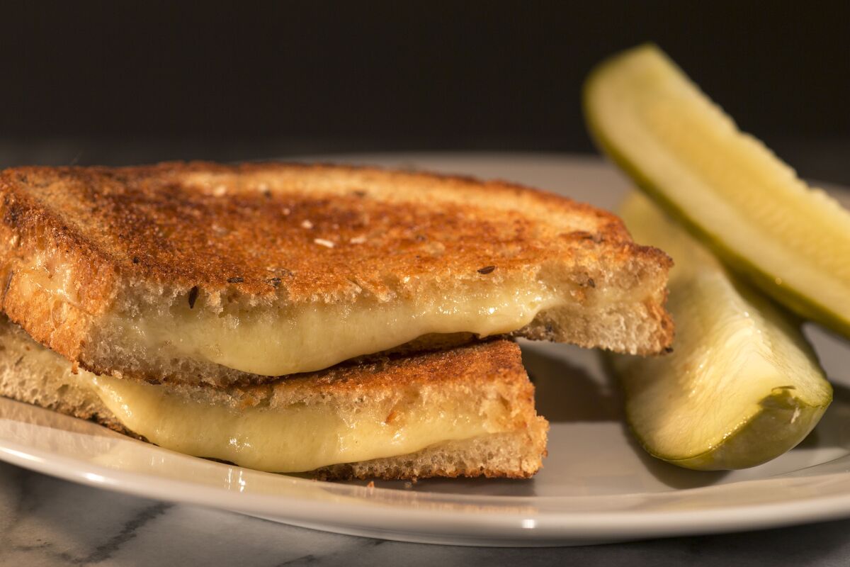 Grilled cheese with Gruyere on rye served with garlic pickles and French mustard. A new survey by social networking site Skout suggests people who love grilled cheese are more active in the bedroom.