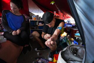As Billy smokes fentanyl inside his tent at a homeless encampment,  Tara Stamos-Buesig tests small samples of the drugs.