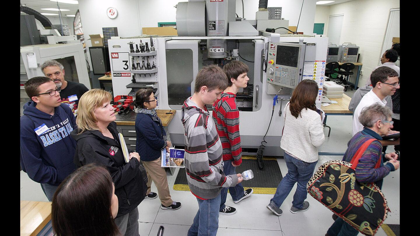 Students and parents are given a tour of the Engineering Design Manuafacturing HUB, where the future classes will be held, at an information meeting for a brand new program called the Uniquely Abled Academy at Glendale Community College on Thursday, May 5, 2016. The academy trains high-functioning autistic students how to use a CNC machine.