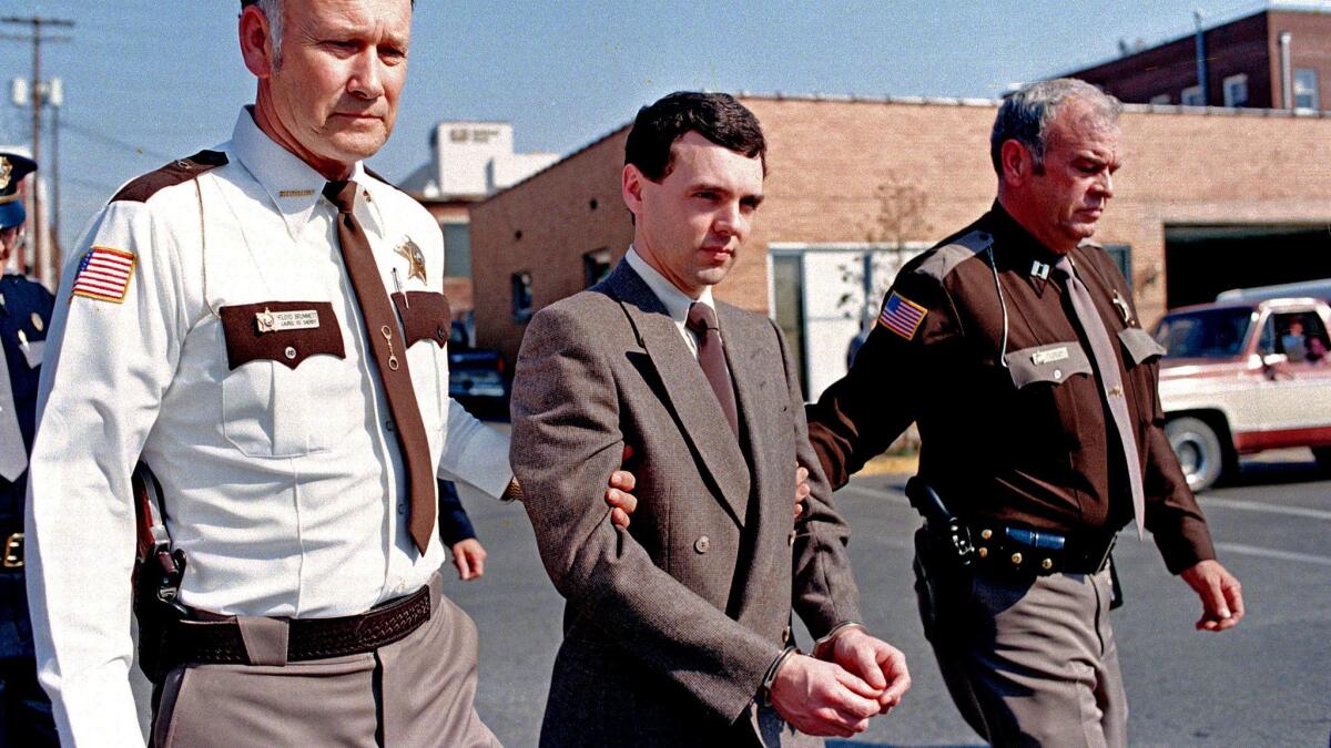 Convicted killer Donald Harvey, center, is led back to jail in 1987 after pleading guilty to eight murder charges and one voluntary manslaughter charge in London, Ky.
