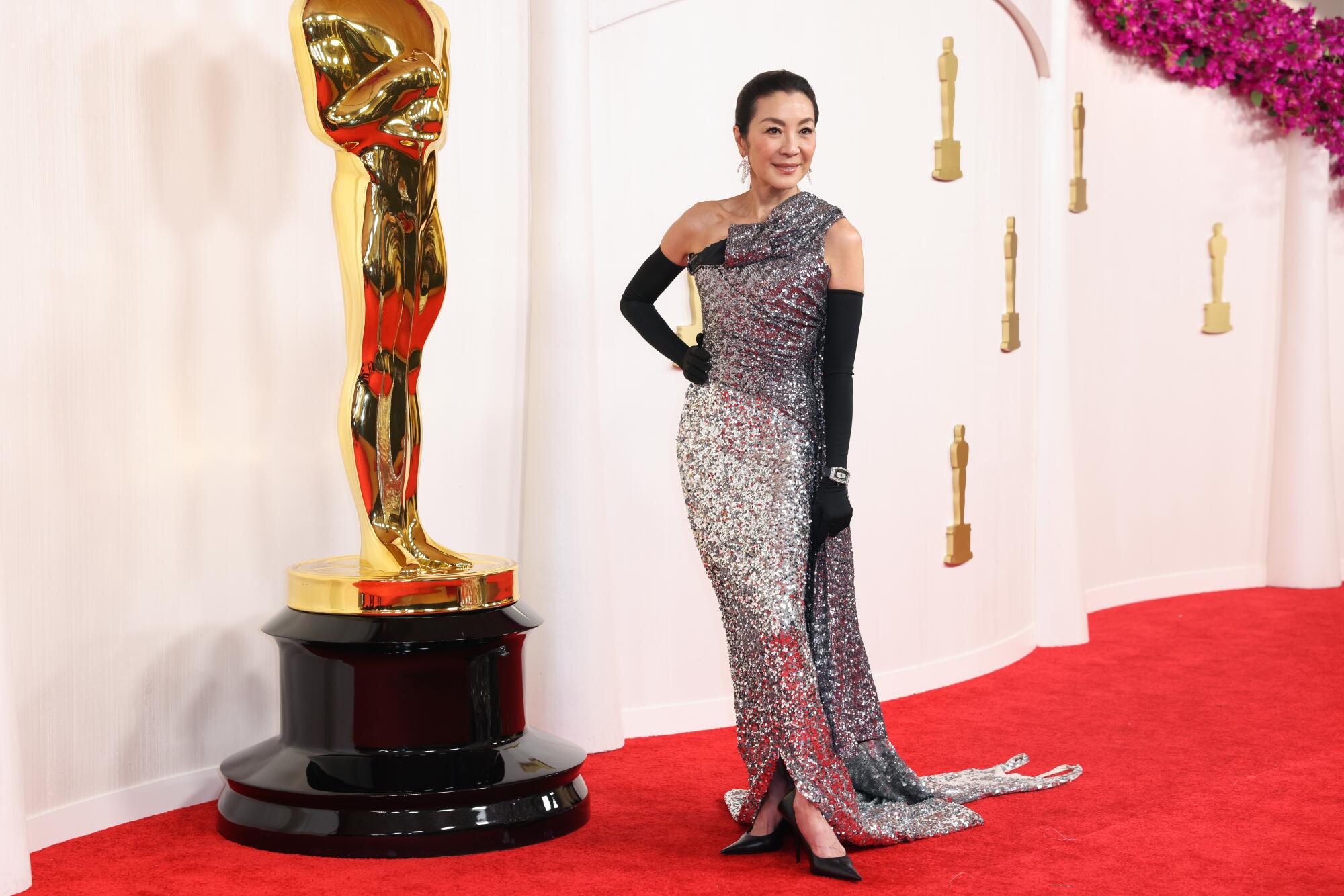 Michelle Yeoh wears a silver sequined gown. 