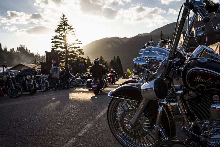 Motorcycles line Main Street in Red River, N.M., Sunday, May 28, 2023. Three people were killed in a shootout Saturday during a Memorial Day motorcycle rally. (Chancey Bush/The Albuquerque Journal via AP)