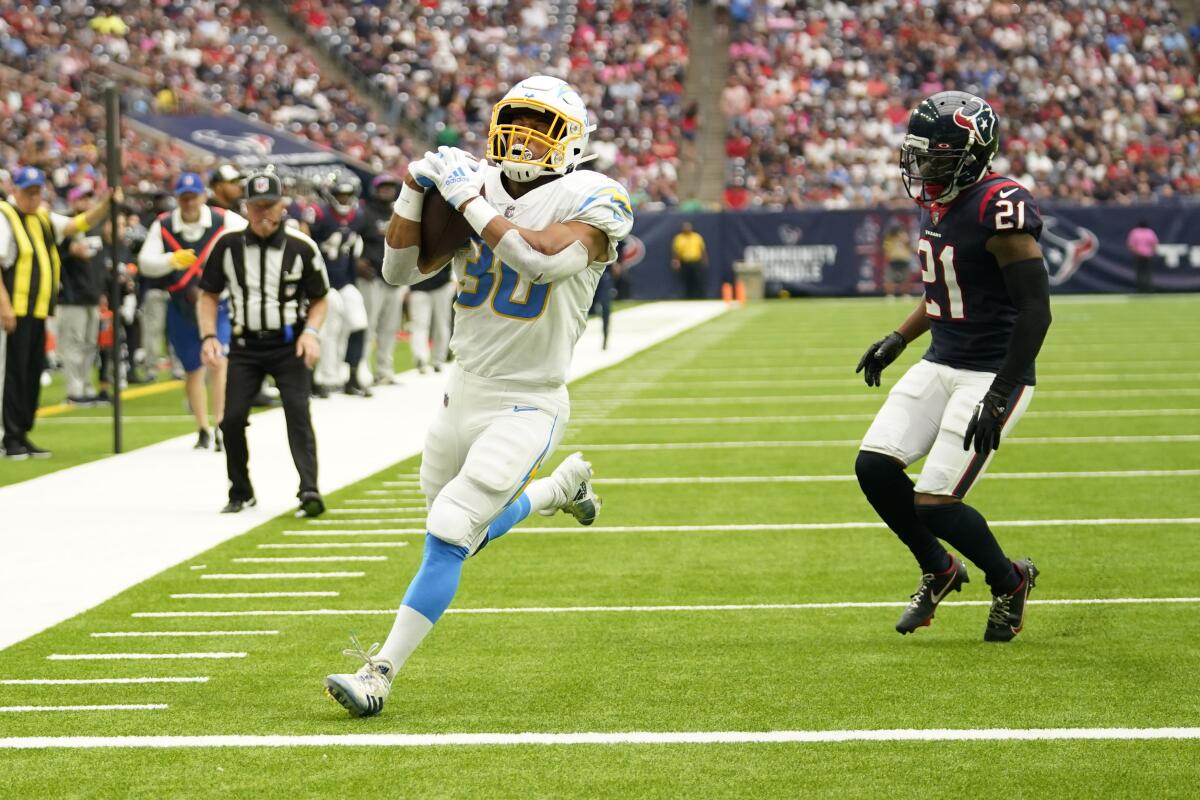 Austin Ekeler runs for a Chargers touchdown past Houston Texans cornerback Steven Nelson in the first half. 