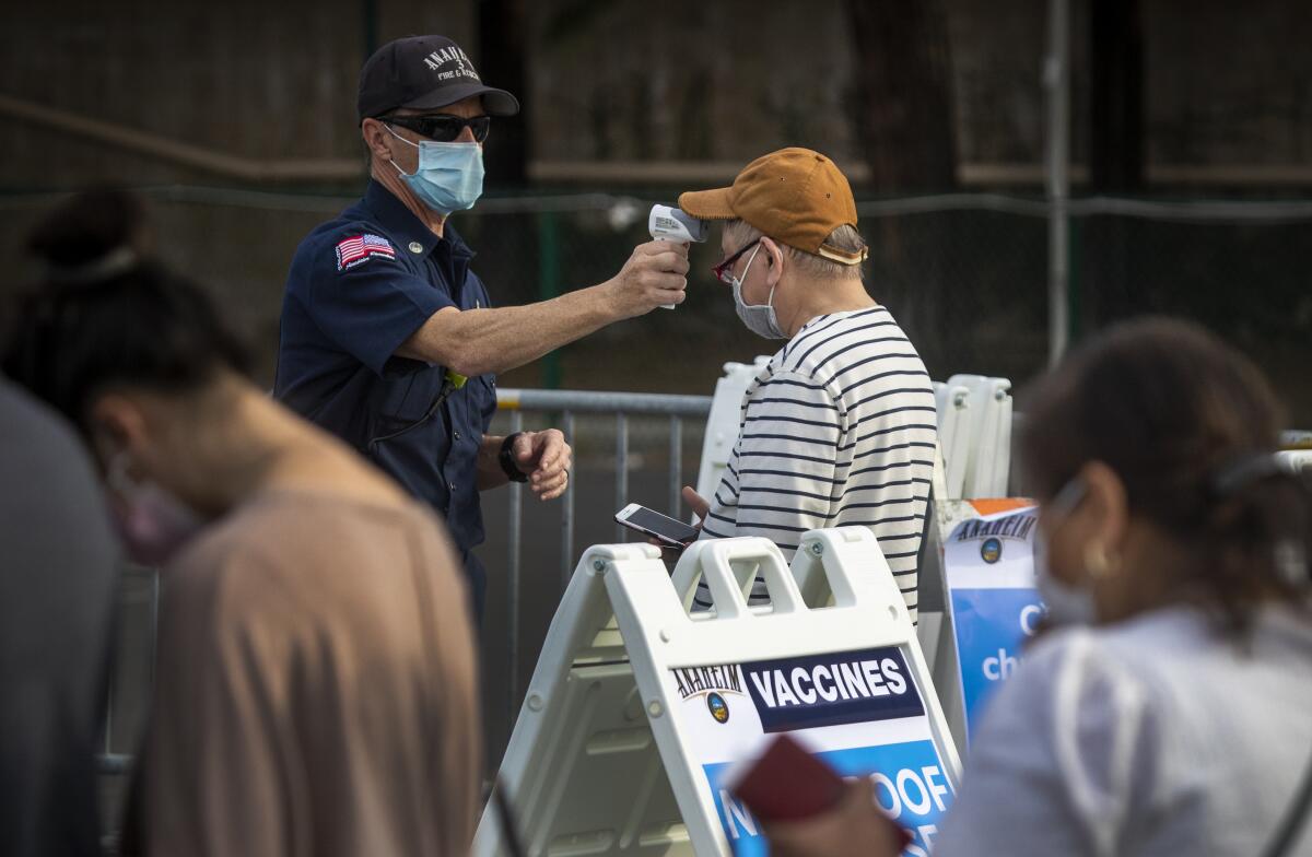 A man's temperature is checked at the Disneyland COVID-19 vaccination site in January.