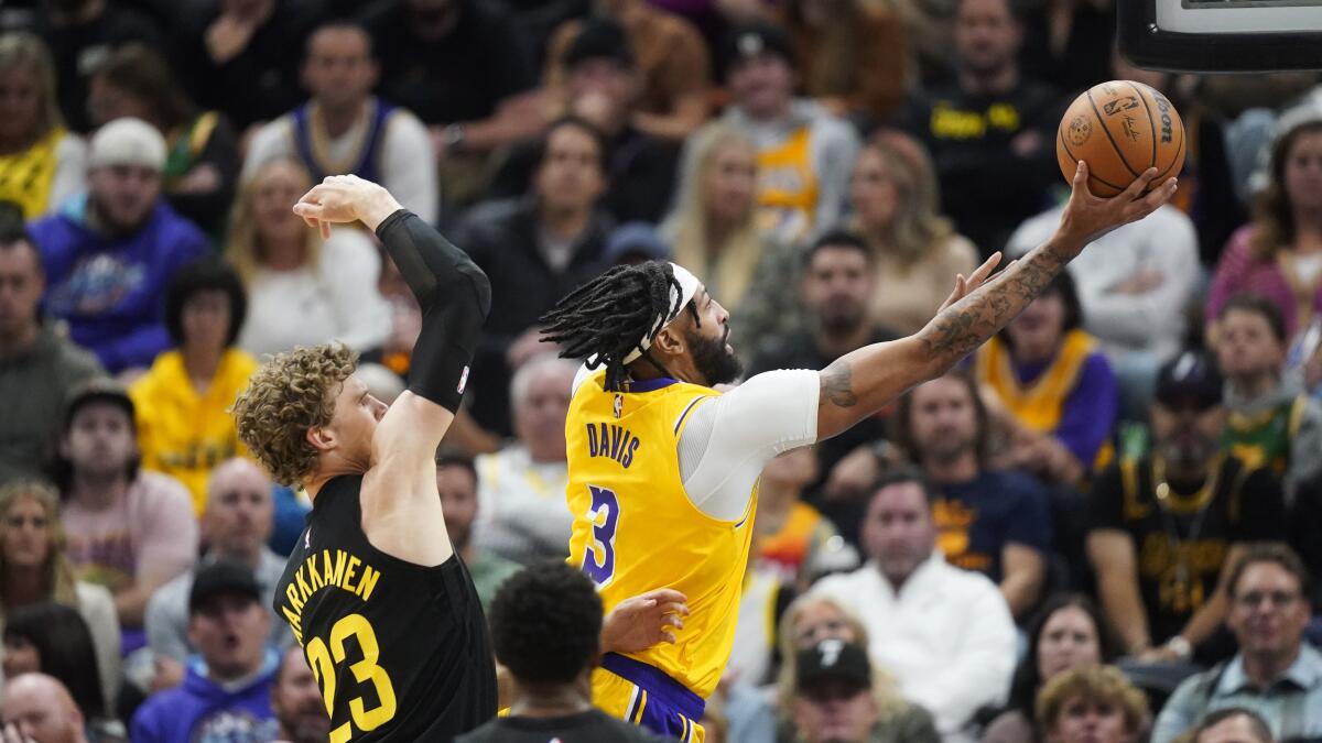 Lakers forward Anthony Davis puts up a shot in front of Utah Jazz forward Lauri Markkanen.