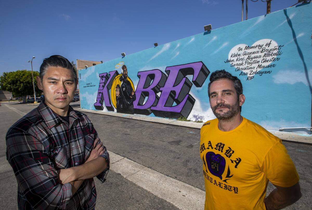Tyke Witnes left, and Mike Asner, creator of Kobemural.com, at Witnes' mural at El Toro Bravo Tortilleria in Costa Mesa.