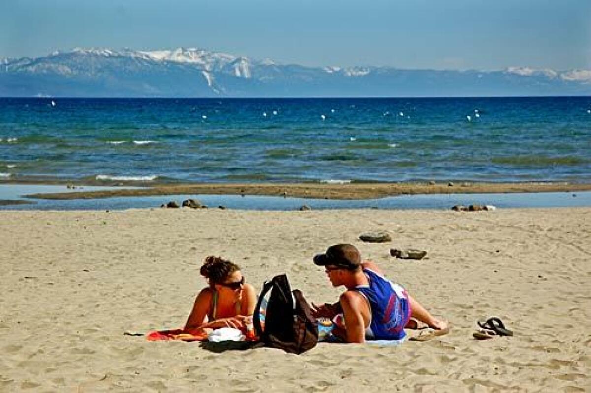 A couple enjoys elbow room ahead of the summer crowds at Moon Dunes Beach on Lake Tahoe's north shore.