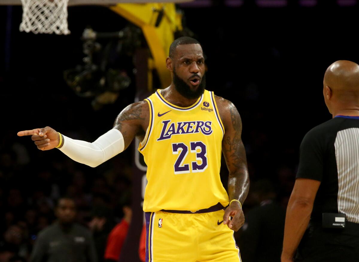 The Lakers' LeBron James talks with an official during Wednesday's game against the Kings.