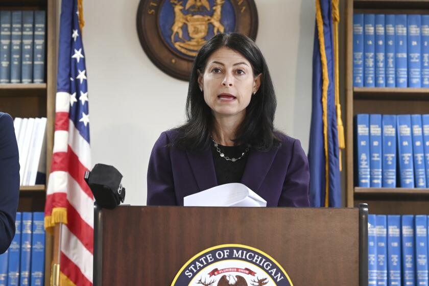 FILE - Attorney General Dana Nessel announces charges for several security guards from Northland Mall in the 2014 death of McKenzie Cochran during a news conference in Detroit on Thursday, Oct. 14, 2021. Nessel is asking federal prosecutors, Thursday, Jan. 13, 2022, to open a criminal investigation into 16 Republicans who submitted false certificates stating they were the state’s presidential electors despite Joe Biden’s 154,000-vote victory in 2020. (Max Ortiz/Detroit News via AP)