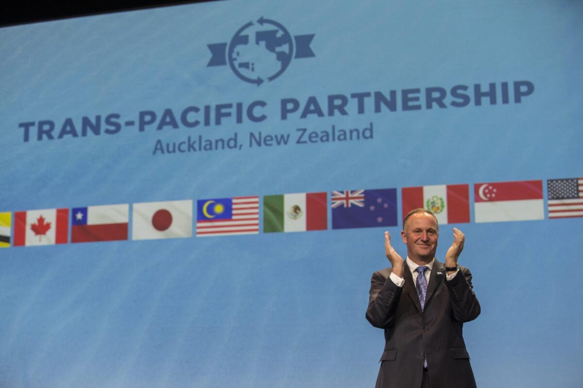 New Zealand Prime Minister John Key clapping during the signing of the Trans Pacific Partnership trade agreement in Auckland, New Zealand, on Feb. 4, 2016.