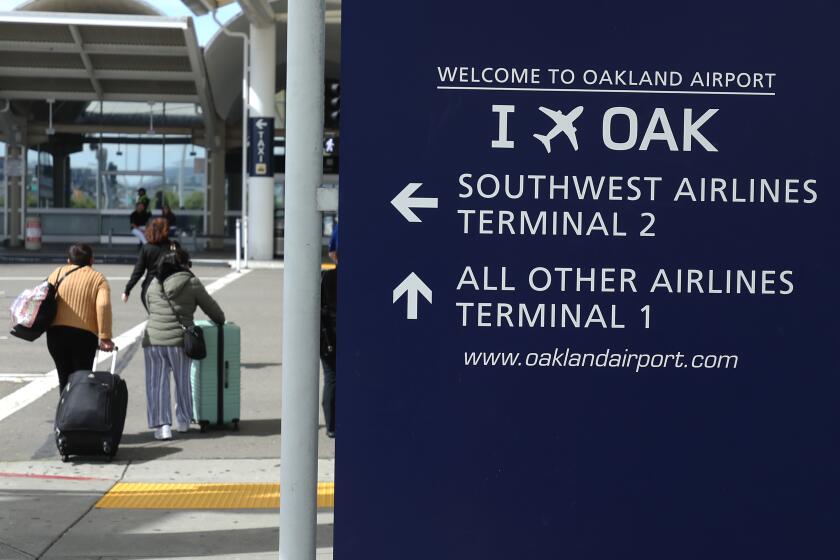 OAKLAND, CALIFORNIA - APRIL 12: Travelers walk towards Terminal 1 at Oakland International Airport on April 12, 2024 in Oakland, California. The Board of Commissioners for the Port of Oakland voted on Thursday to proceed with a plan to change the name of Oakland International Airport to the San Francisco Bay Oakland International Airport. San Francisco officials are objecting to the proposed name change and have threatened to file a lawsuit arguing it would violate the city’s trademark on San Francisco International Airport and would potentially be confusing for people traveling to the area. (Photo by Justin Sullivan/Getty Images)
