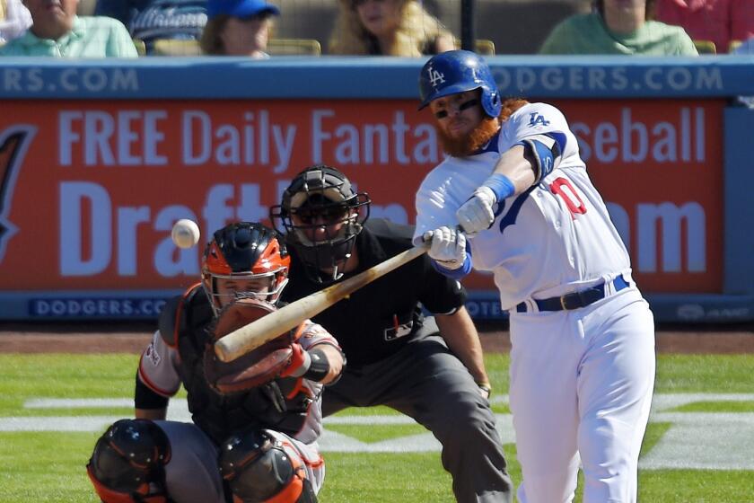 Justin Turner hits the second of back-to-back Dodgers home runs in the first inning against San Francisco on June 20.