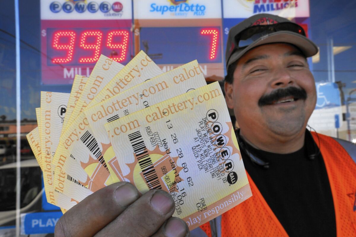 Edward Calderon, 50, of Wilmington holds $20 worth of Powerball tickets that he bought at Mr. C's Liquor in San Pedro.