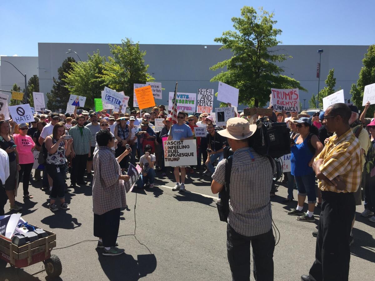 Close to 1,000 protesters rallied outside the Reno-Sparks Convention Center in Nevada as President Trump addressed an American Legion convention.