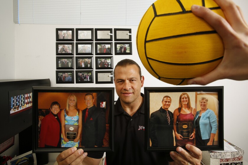Marcelo Leonardi, Cal State Northridge women's water polo coach, holds up photographs of two former players Kristin McLaughlin, left, and Jillian Stapf, who won Big West Scholar Athlete of the Year honors during their respective tenures with the Matadors.