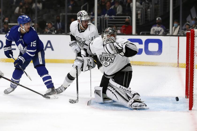Toronto Maple Leafs center Alexander Kerfoot, gets the puck by Los Angeles Kings center Anze Kopitar, center, and goaltender Jonathan Quick, right, to score during the first period of an NHL hockey game in Los Angeles, Wednesday, Nov. 24, 2021. (AP Photo/Alex Gallardo)
