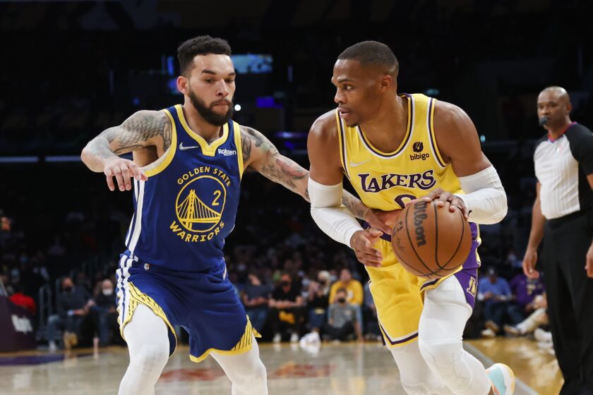 Los Angeles Lakers guard Russell Westbrook (0) drives against Golden State Warriors forward Chris Chiozza (2) during the first half of a preseason NBA basketball game in Los Angeles, Tuesday, Oct. 12, 2021. (AP Photo/Ringo H.W. Chiu)