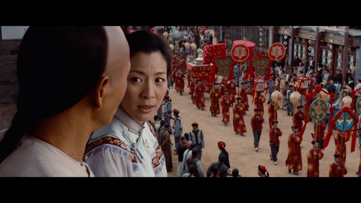 A man and a woman look at each other in the movie "Crouching Tiger, Hidden Dragon."
