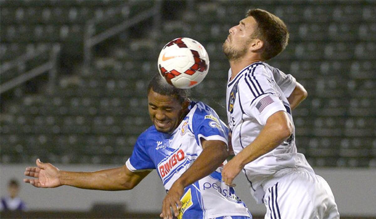 Isidro Metapan's Hector Ramos and the Galaxy's Tommy Meyer fight for the header during L.A.'s 1-0 victory in the CONCACAF Champions League tournament match.