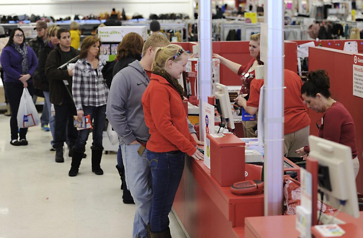 In this Dec. 26, 2013, file photo, Ally Belden, center, returns an item at Target in Summit Township, Pa.