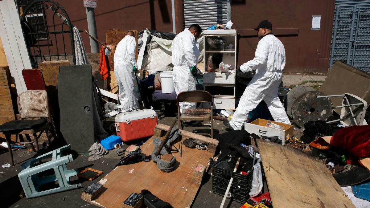 Los Angeles biohazard workers clean and dispose of chemicals, human feces and sharp objects during a cleaning in May.