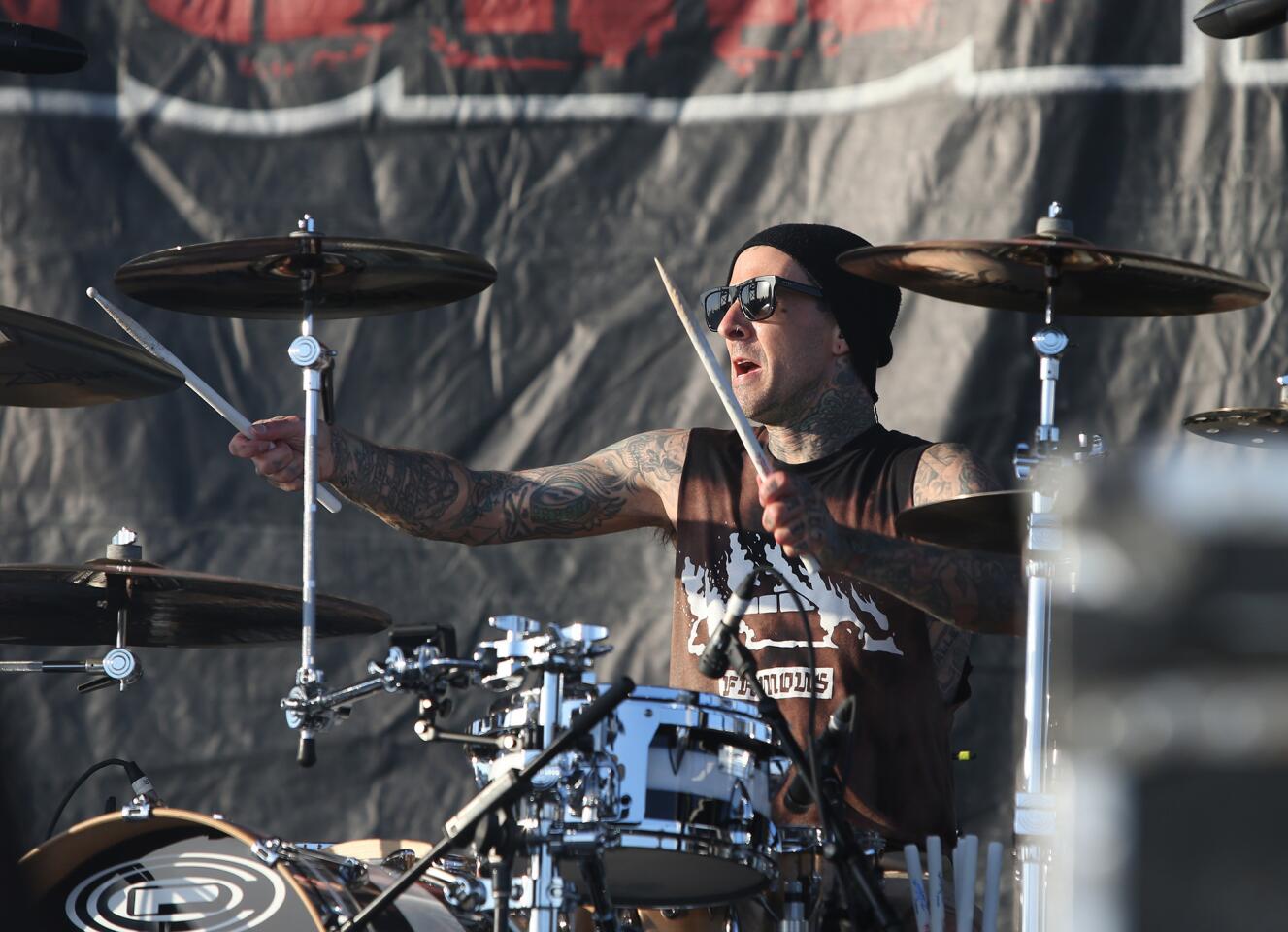 Festival co-presenter Travis Barker of Blink-182 plays drums for Goldfinger during the Back to the Beach Festival on Sunday at Huntington State Beach.